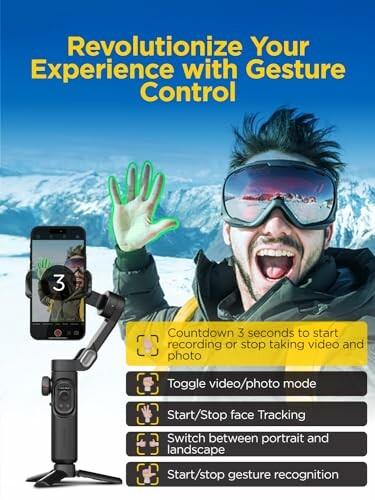 Person using gesture control with camera and smartphone in snowy landscape.