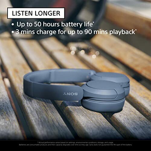 Sony headphones on a bench with battery life details.